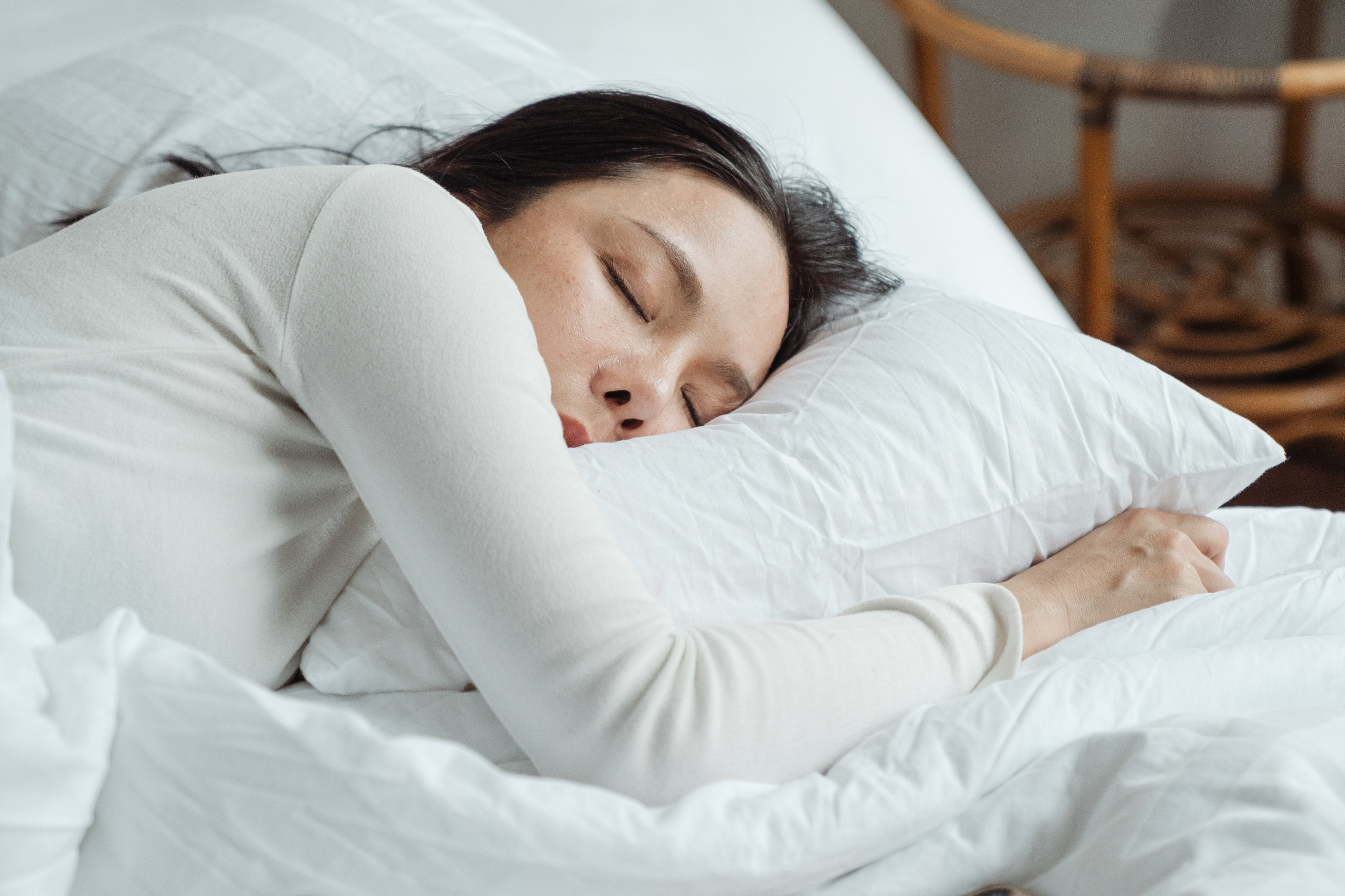 Picture of a woman with her head resting on a pillow.